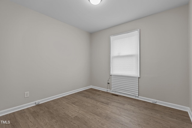 spare room with hardwood / wood-style flooring