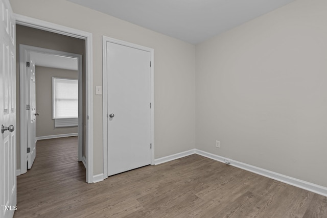 unfurnished bedroom featuring hardwood / wood-style floors