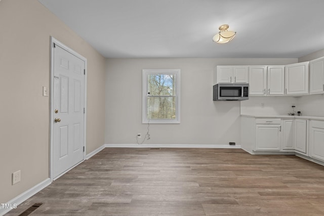 kitchen with white cabinets and light wood-type flooring