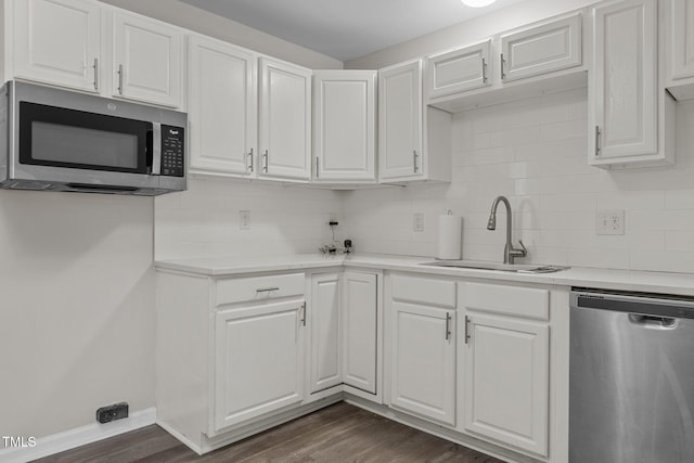 kitchen with white cabinetry, sink, stainless steel appliances, and dark hardwood / wood-style floors