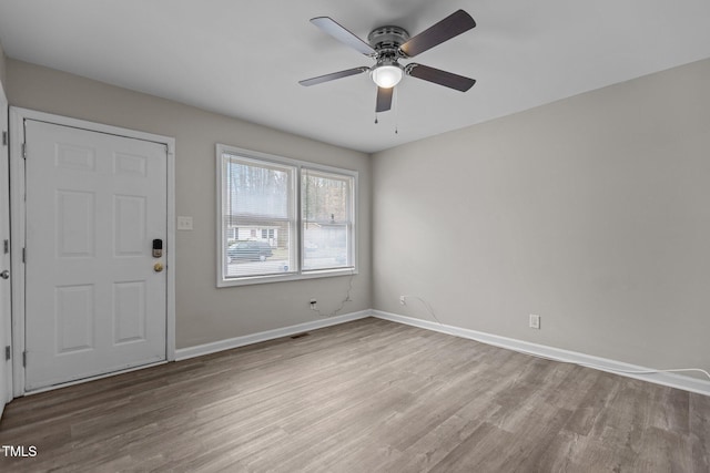 foyer entrance featuring wood-type flooring and ceiling fan