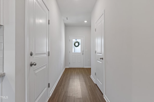 entryway with dark hardwood / wood-style flooring