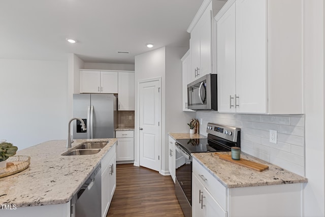 kitchen featuring appliances with stainless steel finishes, white cabinetry, and dark wood-style flooring