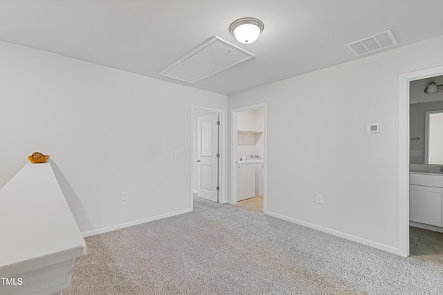 unfurnished room with baseboards, visible vents, carpet floors, and attic access