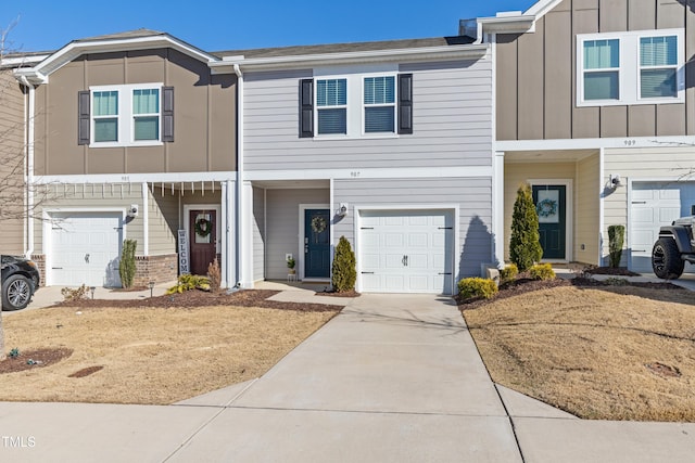 view of property featuring an attached garage, board and batten siding, and driveway