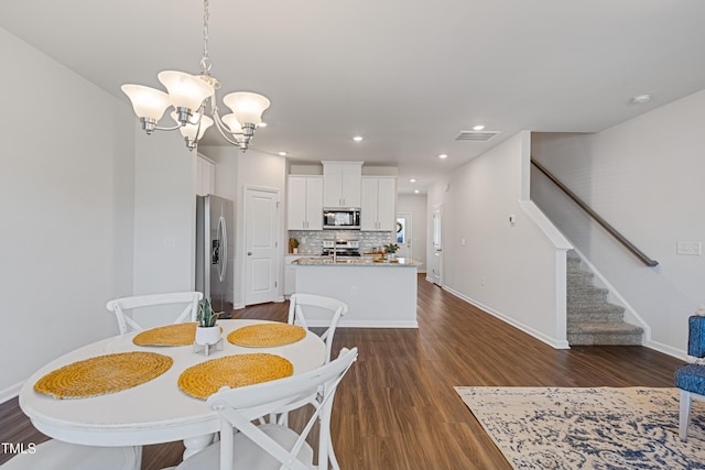 dining room with stairway, baseboards, dark wood finished floors, recessed lighting, and a notable chandelier