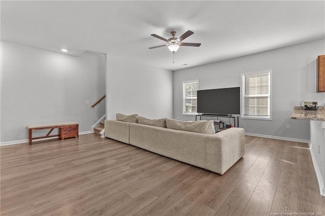 living room with ceiling fan and light hardwood / wood-style floors