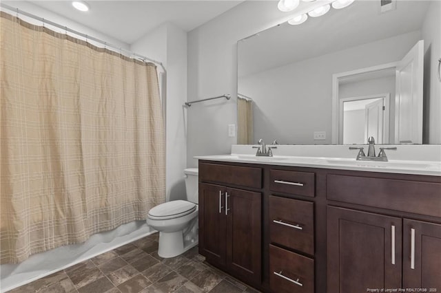 full bathroom with vanity, toilet, and shower / tub combo