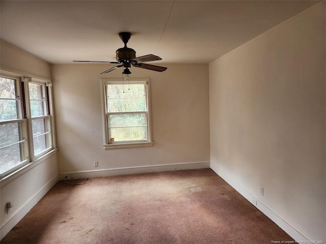 carpeted spare room with ceiling fan