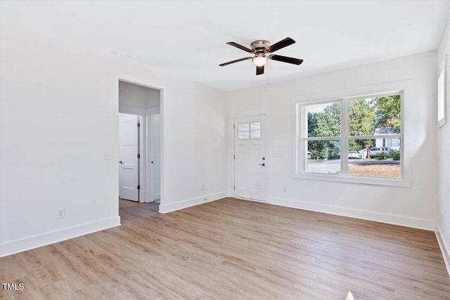 spare room with ceiling fan and light wood-type flooring