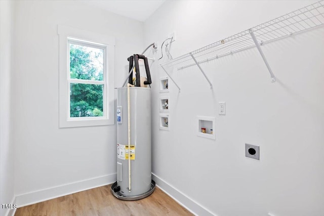 laundry area with hardwood / wood-style flooring, hookup for an electric dryer, electric water heater, and washer hookup