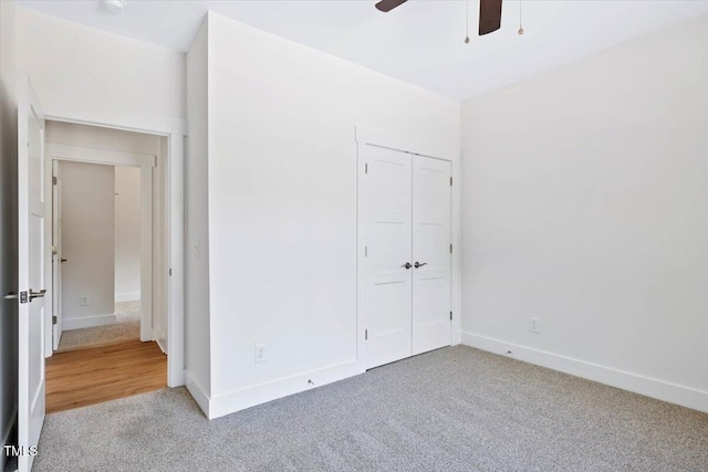 unfurnished bedroom featuring a closet, ceiling fan, and carpet