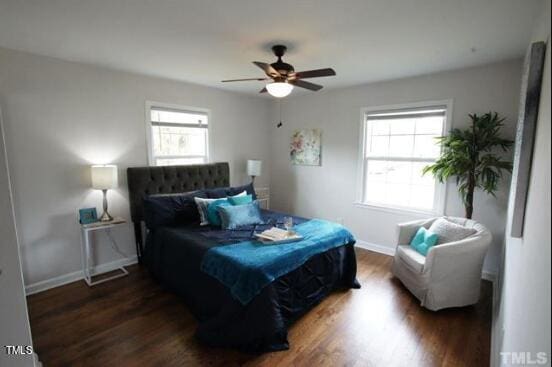 bedroom with ceiling fan and dark hardwood / wood-style flooring