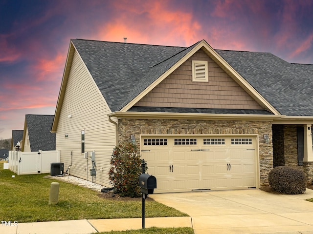 view of front facade with a garage and a lawn