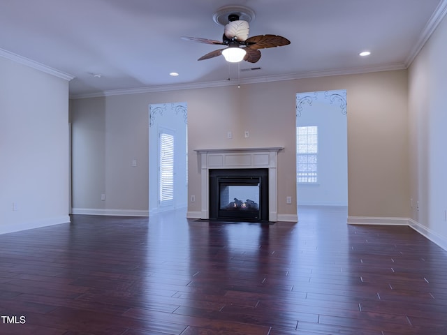 unfurnished living room featuring dark hardwood / wood-style flooring, ornamental molding, ceiling fan, and a multi sided fireplace