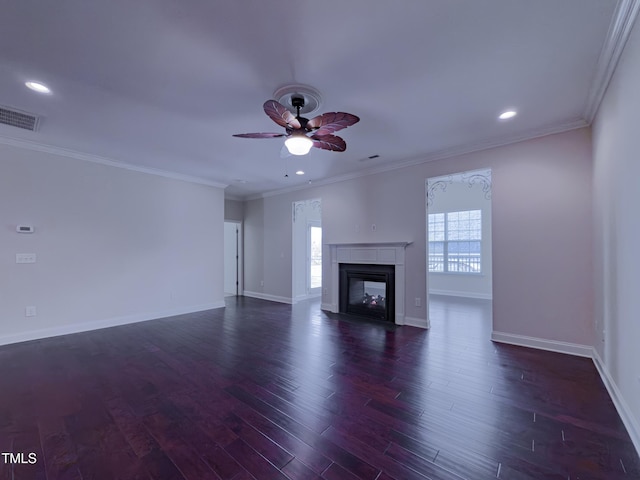 unfurnished living room with a multi sided fireplace, ornamental molding, ceiling fan, and dark hardwood / wood-style flooring