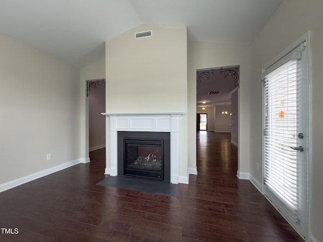 unfurnished living room featuring dark hardwood / wood-style flooring, vaulted ceiling, and plenty of natural light