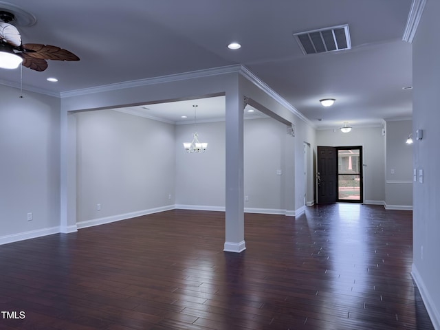 basement featuring ornamental molding, dark wood-type flooring, and ceiling fan with notable chandelier