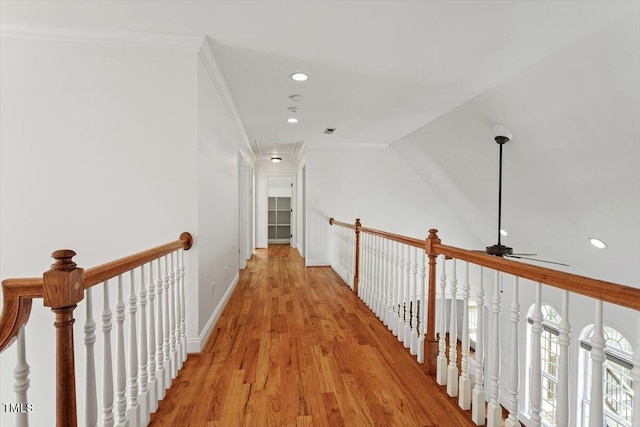 corridor featuring light wood-style flooring, recessed lighting, an upstairs landing, and attic access