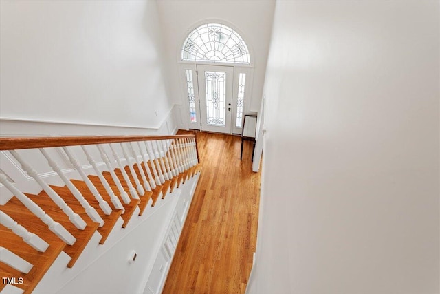 entryway with light wood-style floors and stairs