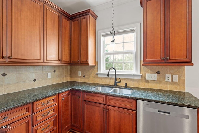 kitchen with dark stone counters, dishwasher, backsplash, pendant lighting, and a sink