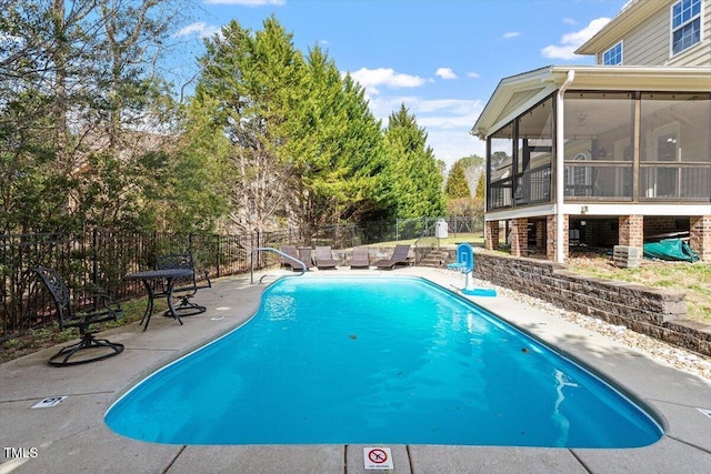 view of swimming pool featuring a fenced in pool, a sunroom, a patio area, and fence