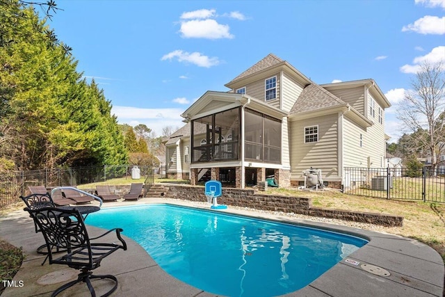 view of swimming pool featuring a sunroom, a patio area, and fence