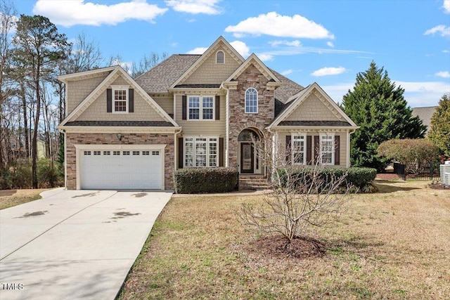 view of front of house with a garage, a front yard, stone siding, and concrete driveway