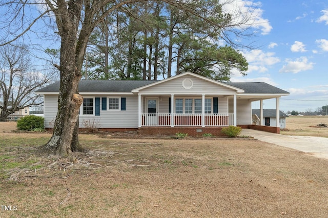 single story home with a carport, covered porch, and a front lawn