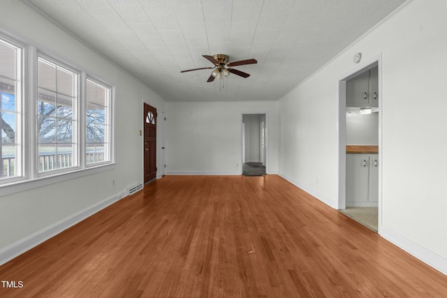 unfurnished living room featuring hardwood / wood-style floors and ceiling fan