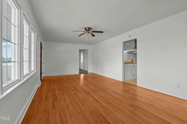 spare room featuring ceiling fan and light hardwood / wood-style flooring