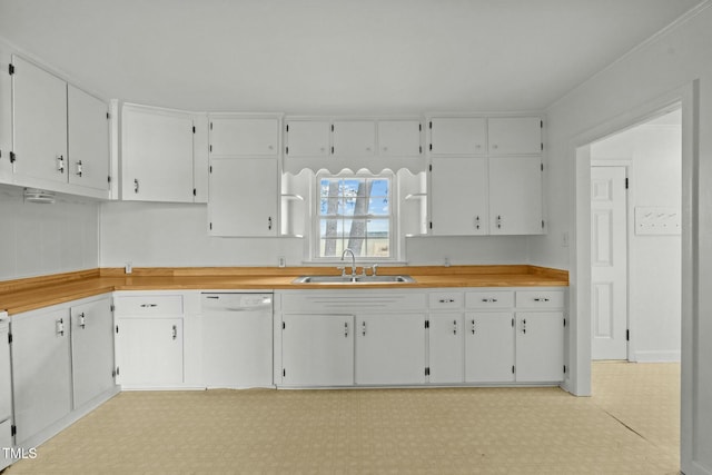 kitchen with white cabinetry, dishwasher, and sink