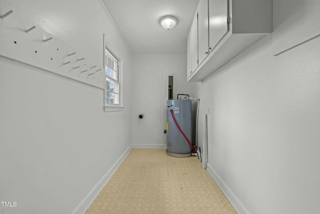 interior space with water heater and cabinets