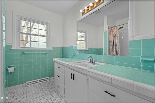 bathroom featuring walk in shower, vanity, tile patterned flooring, and tile walls