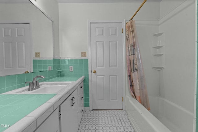 bathroom featuring tile walls, vanity, and shower / bath combo