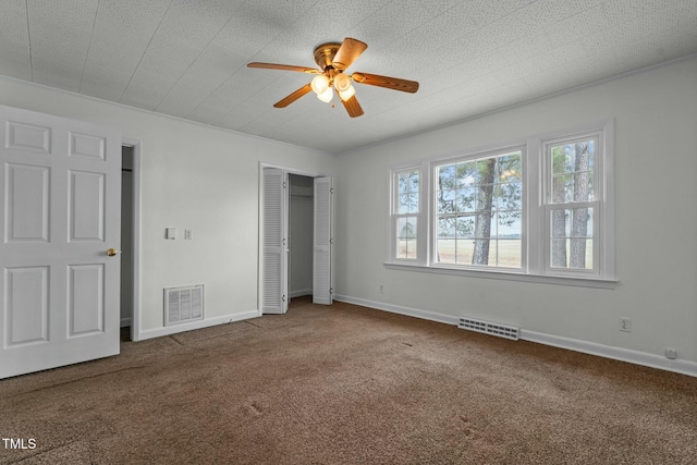 unfurnished bedroom with a closet, ceiling fan, and carpet flooring