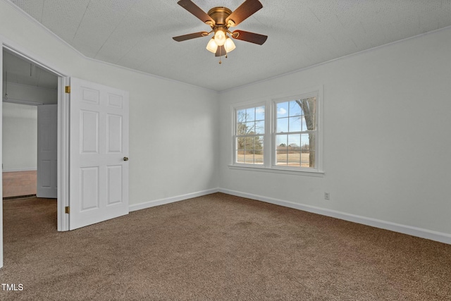 carpeted spare room with ceiling fan and a textured ceiling