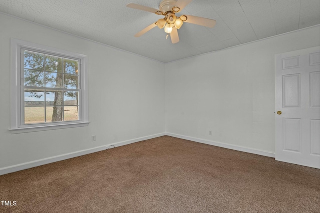 carpeted empty room featuring ceiling fan and a textured ceiling