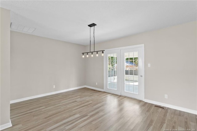 unfurnished dining area featuring light hardwood / wood-style floors