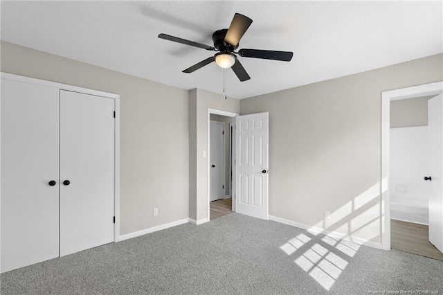 unfurnished bedroom with carpet floors, a closet, and ceiling fan