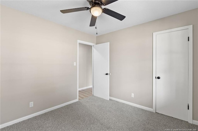 unfurnished bedroom with light carpet and ceiling fan