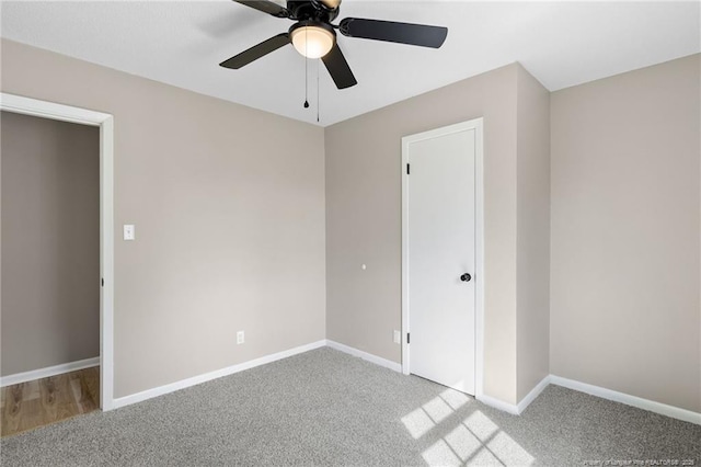 unfurnished bedroom with ceiling fan and light colored carpet