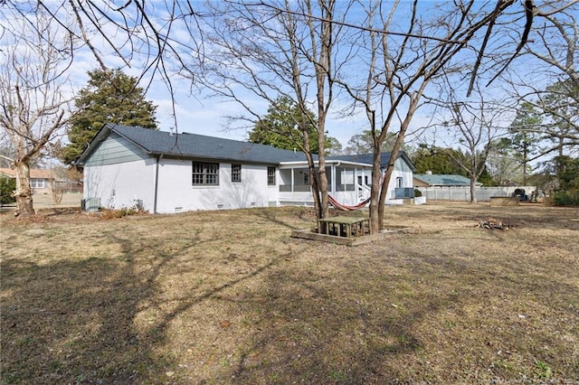 rear view of property with a yard