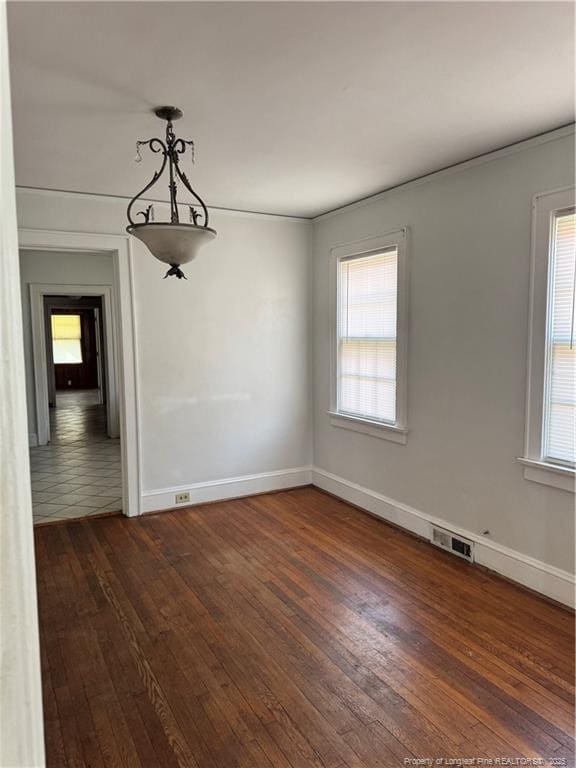 unfurnished dining area with dark wood-type flooring and a wealth of natural light