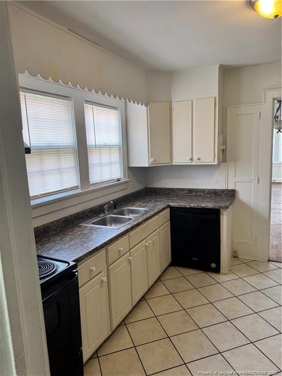 kitchen featuring sink, light tile patterned floors, and black appliances