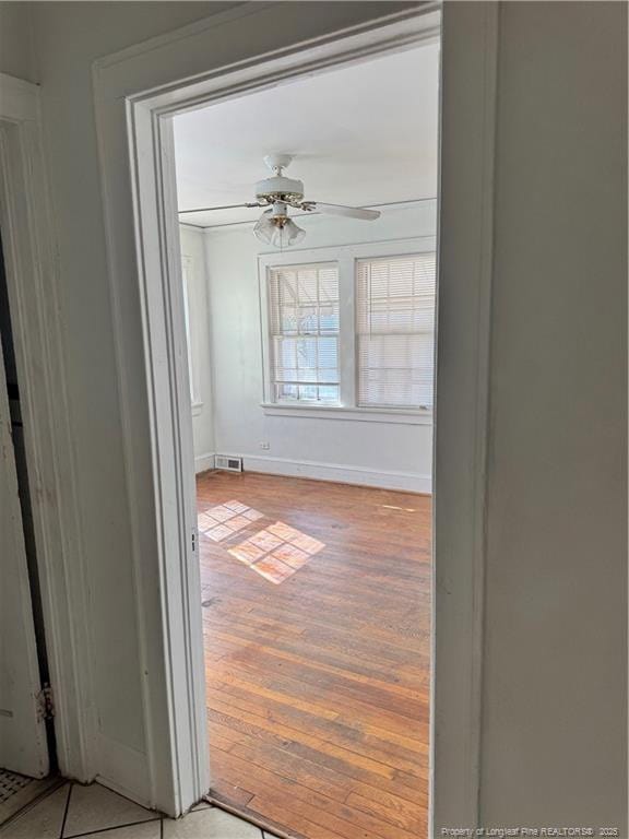 spare room with ceiling fan and light wood-type flooring