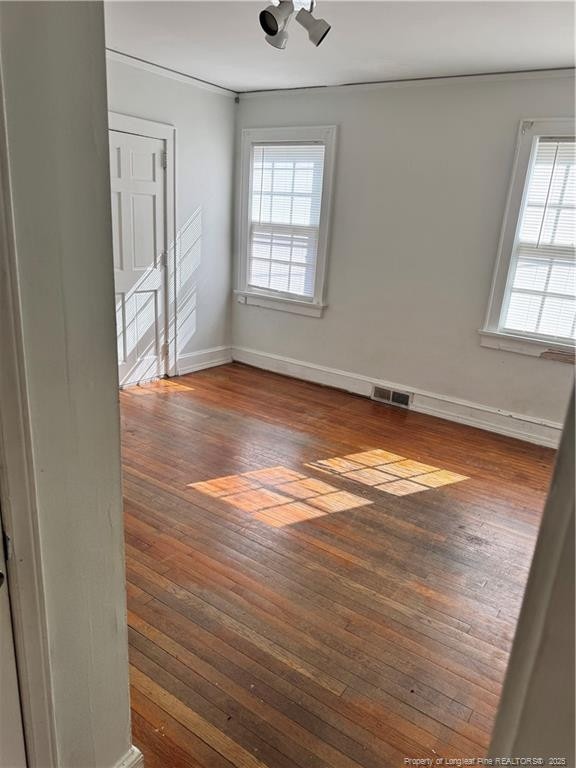 empty room featuring dark wood-type flooring