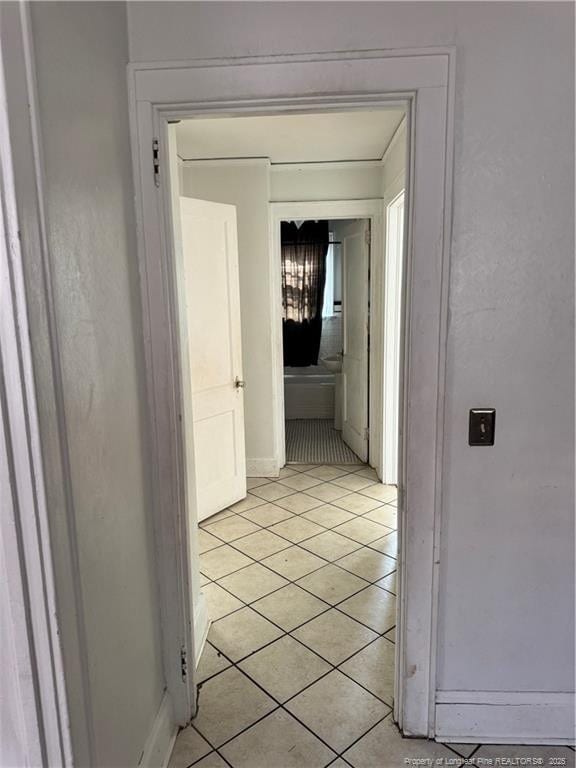 hall featuring light tile patterned floors