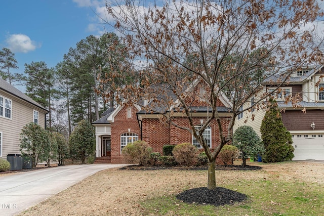 front facade with cooling unit, a garage, and a front yard