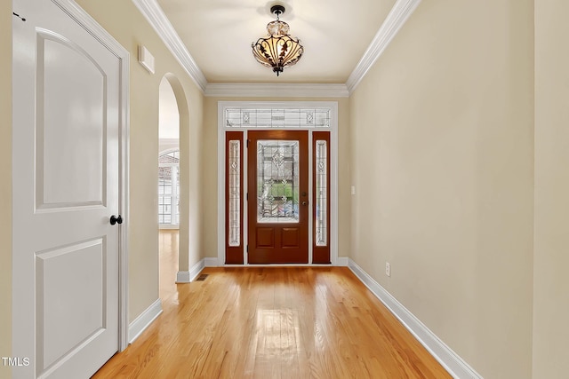 foyer featuring crown molding and light hardwood / wood-style floors